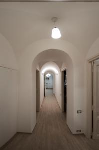 an empty hallway in an office building with a light fixture at La Primavera in Anacapri