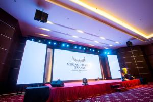 a stage with a large screen in a room at Muong Thanh Grand Hoang Mai - Nghe An in Hoang Mai