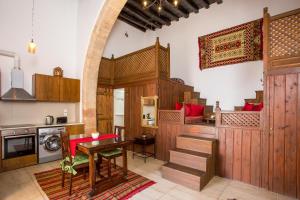 a kitchen with wooden cabinets and a table in a room at CasaLindos Festa in Lindos