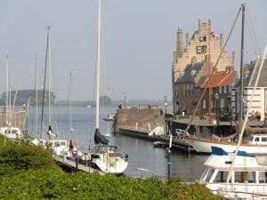 a group of boats docked at a dock in a harbor at Paradise suite in Veere