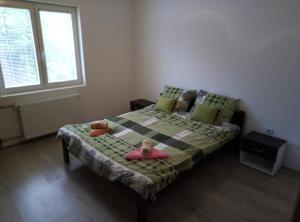 een kleine slaapkamer met een bed met een roze kussen bij Apartman Miljkovic in Arandjelovac