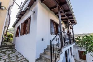 a stairway leading up to a white building with windows at Anastasia House in Panagia