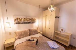 a bedroom with a bed and a painting on the wall at Anastasia House in Panagia