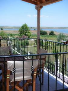 a porch with a table and chairs on a balcony at Hotel Alexandros in Fanari