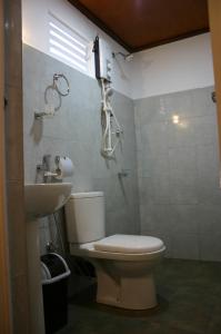a bathroom with a toilet and a sink at JKAB Park Hotel in Trincomalee