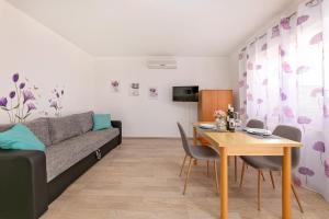 a living room with a couch and a table at Apartments Santos in Vrsar