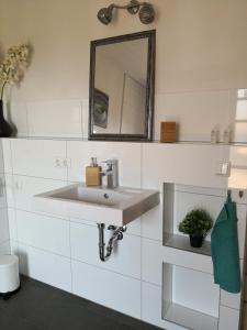 a bathroom with a sink and a mirror at Apartment Ferienwohnung Emmerthal auch für Monteure FeWo in Emmerthal