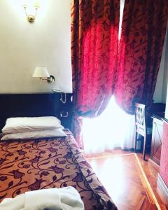 um quarto com uma cama e uma janela com uma cortina em Hotel Best Roma em Roma