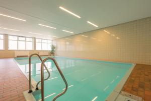 a large swimming pool in a building at Ferienwohnung Kraus in Tiefenbach bei Oberstdorf