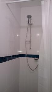 a shower in a bathroom with a shower curtain at Jurnieku nams in Liepāja +28 photos