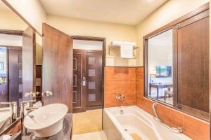 y ba&ntilde;o con ba&ntilde;era, aseo y lavamanos. en Camar Resort Langkawi, en Pantai Cenang