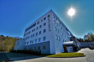 a white building with the sun in the sky at Green Loft Gdynia in Gdynia
