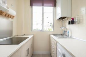 a kitchen with a sink and a window at 14 Mirasierras in Madrid