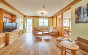a living room with a couch and a tv at Appartements Casa Nuova in Saalbach Hinterglemm