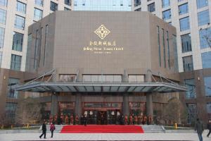 a large building with a red carpet in front of it at Jinling New Town Hotel Nanjing in Nanjing