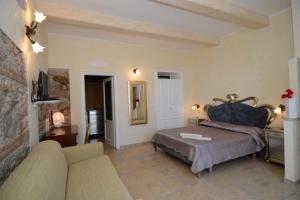 a bedroom with a bed and a couch at Residenza Casale San Francesco free parking in Tropea +215 photos