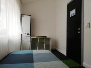 1 dormitorio con cama, silla y espejo en Hostel 365 For U en Dubrovnik