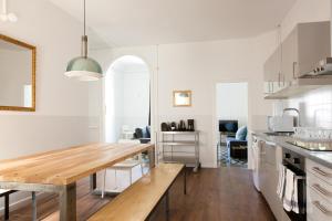a kitchen with a wooden table in a room at My Address in Barcelona in Barcelona