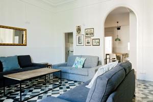 a living room with two blue couches and a table at My Address in Barcelona in Barcelona