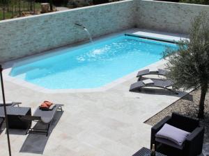 una piscina con due sedie e un tavolo di Superb villa with private pool ad Apt