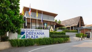 a sign in front of a building with flags at Deevana Plaza Krabi Aonang - SHA Extra Plus in Ao Nang Beach