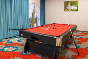 a pool table with balls on it in a room at Dworek Góralski in Łodygowice
