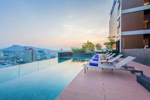 a pool on the roof of a building with a view at Somerset Harbourview Sri Racha - SHA Extra Plus in Si Racha