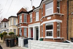 a row of brick houses on a street at Courcy Road - 7 bedroom - sleeps up to 22 in London