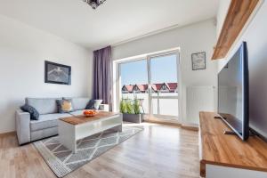 Televízia a/alebo spoločenská miestnosť v ubytovaní Apartamenty Sun & Snow Seaside Grzybowo