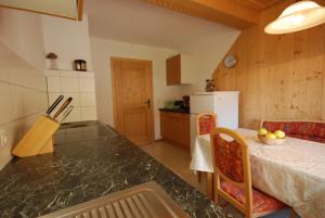 a kitchen with a table and chairs in a room at Ferienhaus "Schneider" in Maria Luggau