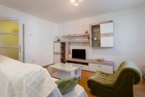 a bedroom with a bed and a tv and a chair at Apartment Anna with FREE private parking in Pula