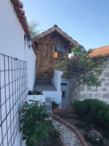 a house with a wooden door and stairs in a yard at Dalmatinska kuća Terace in Skradin