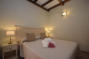 a bedroom with a bed with flowers on it at Krimar Hotel in San Vito lo Capo