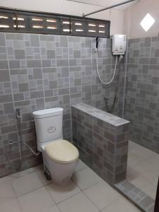 a bathroom with a toilet and a shower at ฟอเรสท์ in Roi Et