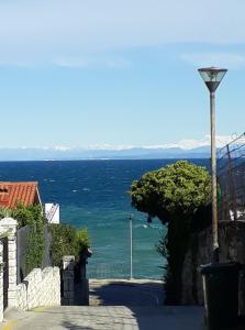 a view of the ocean from a street at Apartments Kolorček in Izola