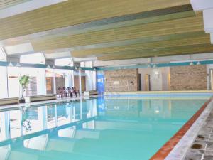 ein großer Pool mit blauem Wasser in einem Gebäude in der Unterkunft Ferienwohnung von Damm in Bad Harzburg