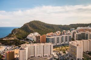 an aerial view of a city with buildings and the ocean at Magic Atrium Beach in Cala de Finestrat