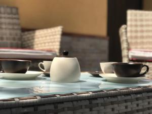 a table with two cups and a tea pot on it at Dependance in villa, Etna, natura, relax in Nicolosi +25 photos