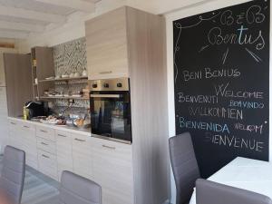 a kitchen with a chalkboard on the wall of a kitchen at Bentus B&B in Villasimius