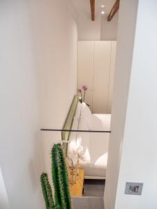 a living room with a white couch and a cactus at Es Palauet Brandnew one suite apartment in Ibiza center in Ibiza Town