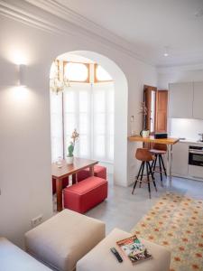 a living room with a table and a dining room at Es Palauet Brandnew one suite apartment in Ibiza center in Ibiza Town +10 photos