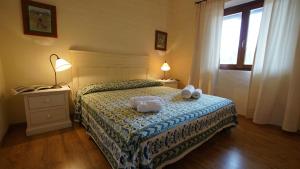 a bedroom with a bed with two towels on it at Italianflat - Villa Cá Rosa in Porto Rotondo