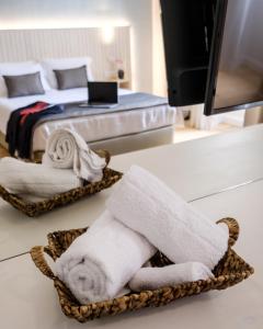 a bathroom with two beds and towels in a room at Limassol Old Town Mansion in Limassol