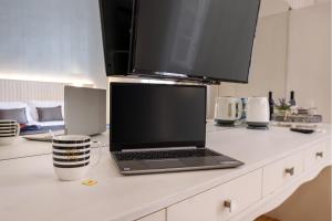 a laptop computer sitting on top of a kitchen counter at Limassol Old Town Mansion - Steps to the Sea , Marina and Center in Limassol
