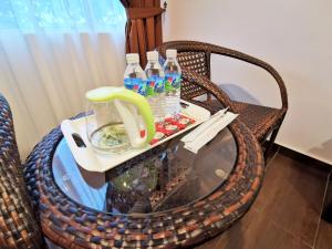 a wicker table with bottles of water on it at Palazzo Hotel Kulai in Kulai