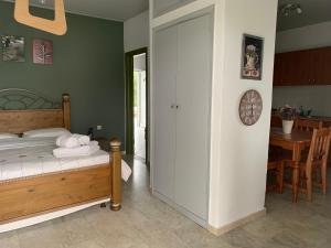 A bed or beds in a room at Anastasios Olive Garden Apartments