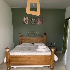 A bed or beds in a room at Anastasios Olive Garden Apartments