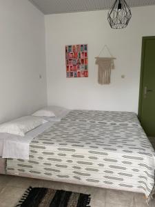 A bed or beds in a room at Anastasios Olive Garden Apartments
