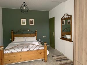 A bed or beds in a room at Anastasios Olive Garden Apartments