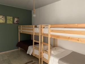 A bed or beds in a room at Anastasios Olive Garden Apartments
